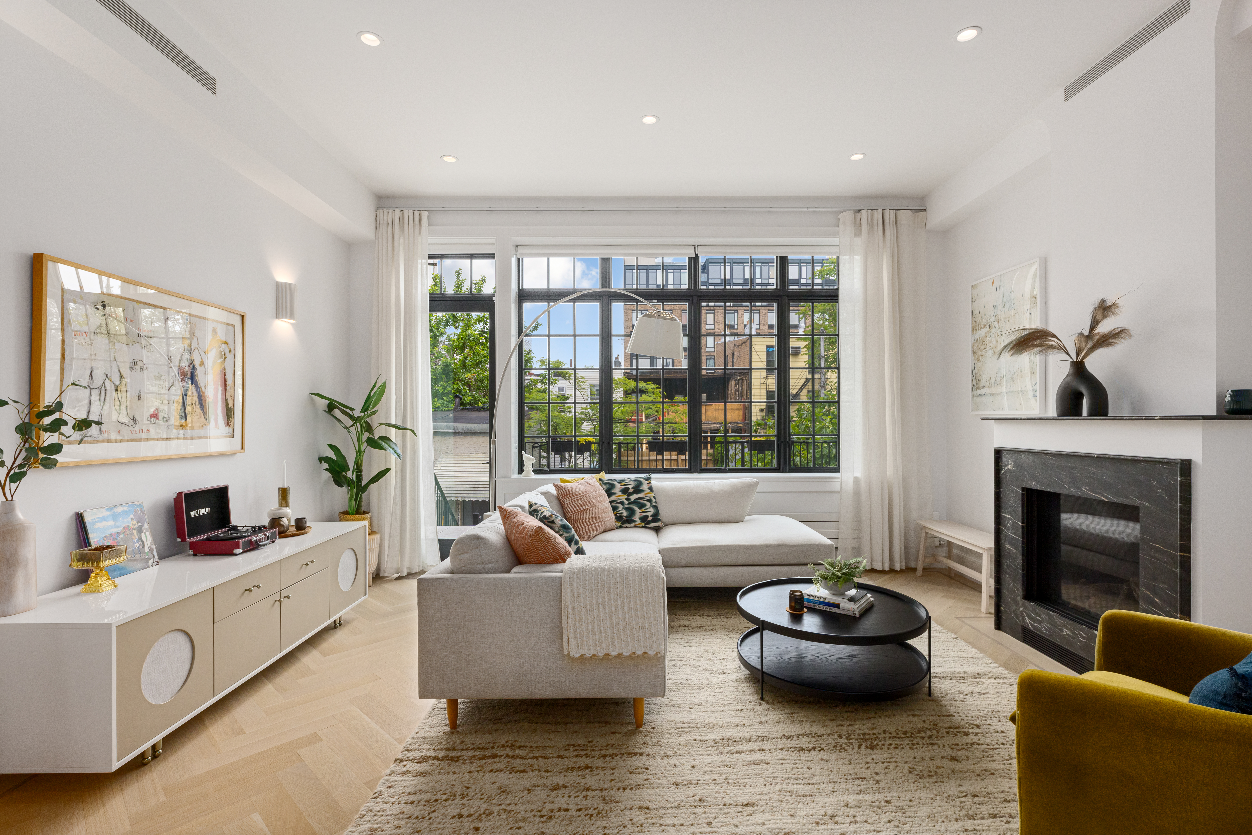 179 Devoe Street Brooklyn, NY 11211 - Photo 1 of 20 a living room with furniture and a fireplace