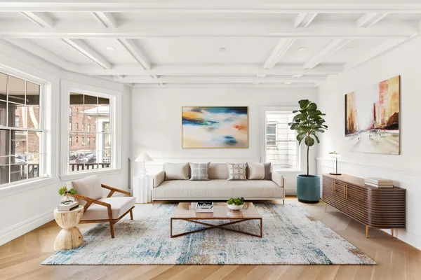 a living room with furniture and a potted plant