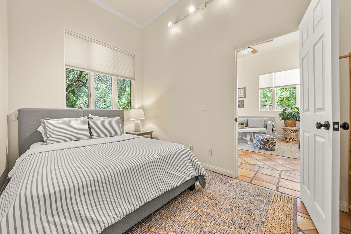 a bedroom with a bed and a large window