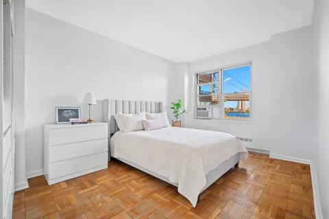 a bedroom with a bed and a window