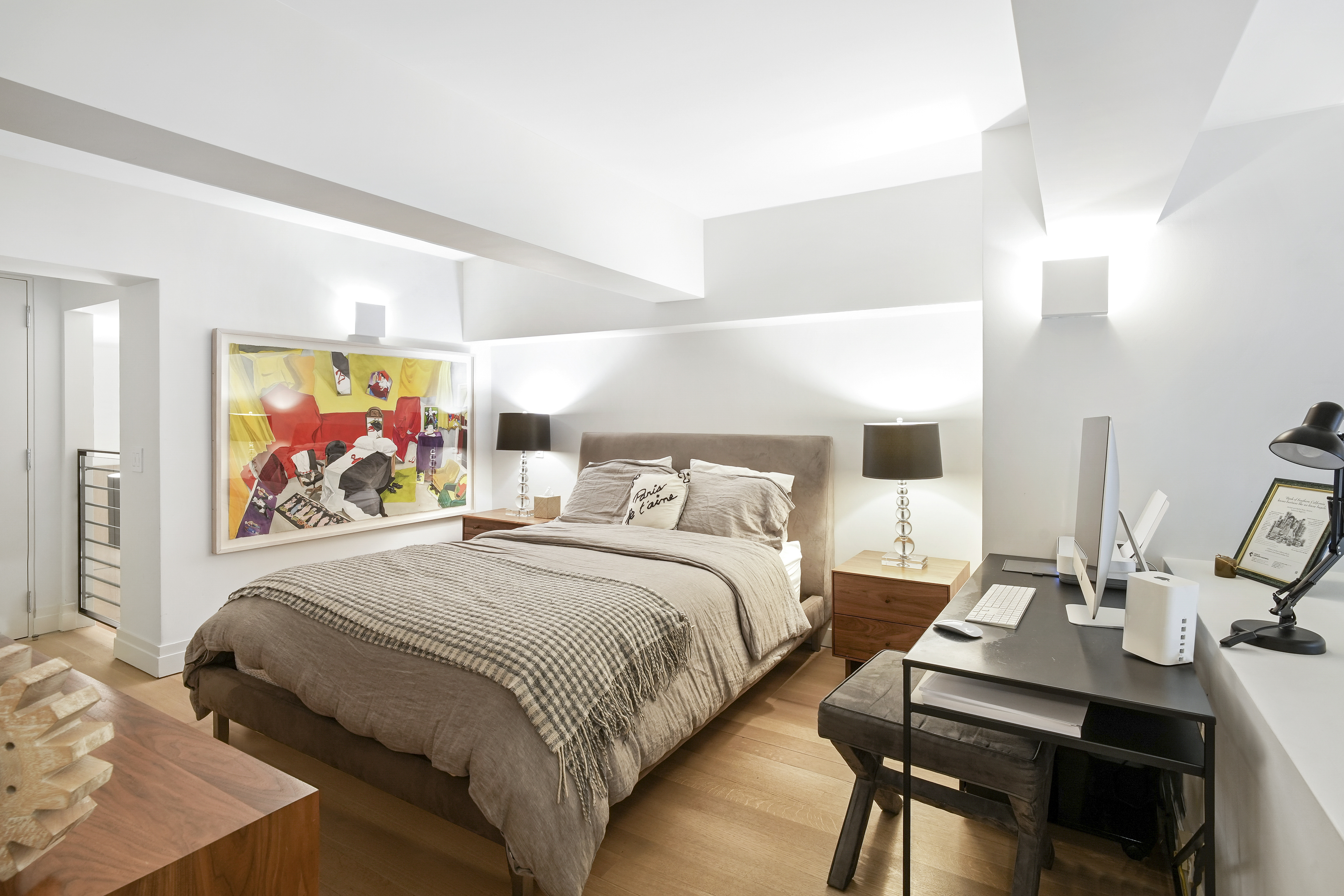 421 Hudson Street, Unit 221 Manhattan, NY 10014 - Photo 9 of 12 a bedroom with a bed and a wall painting