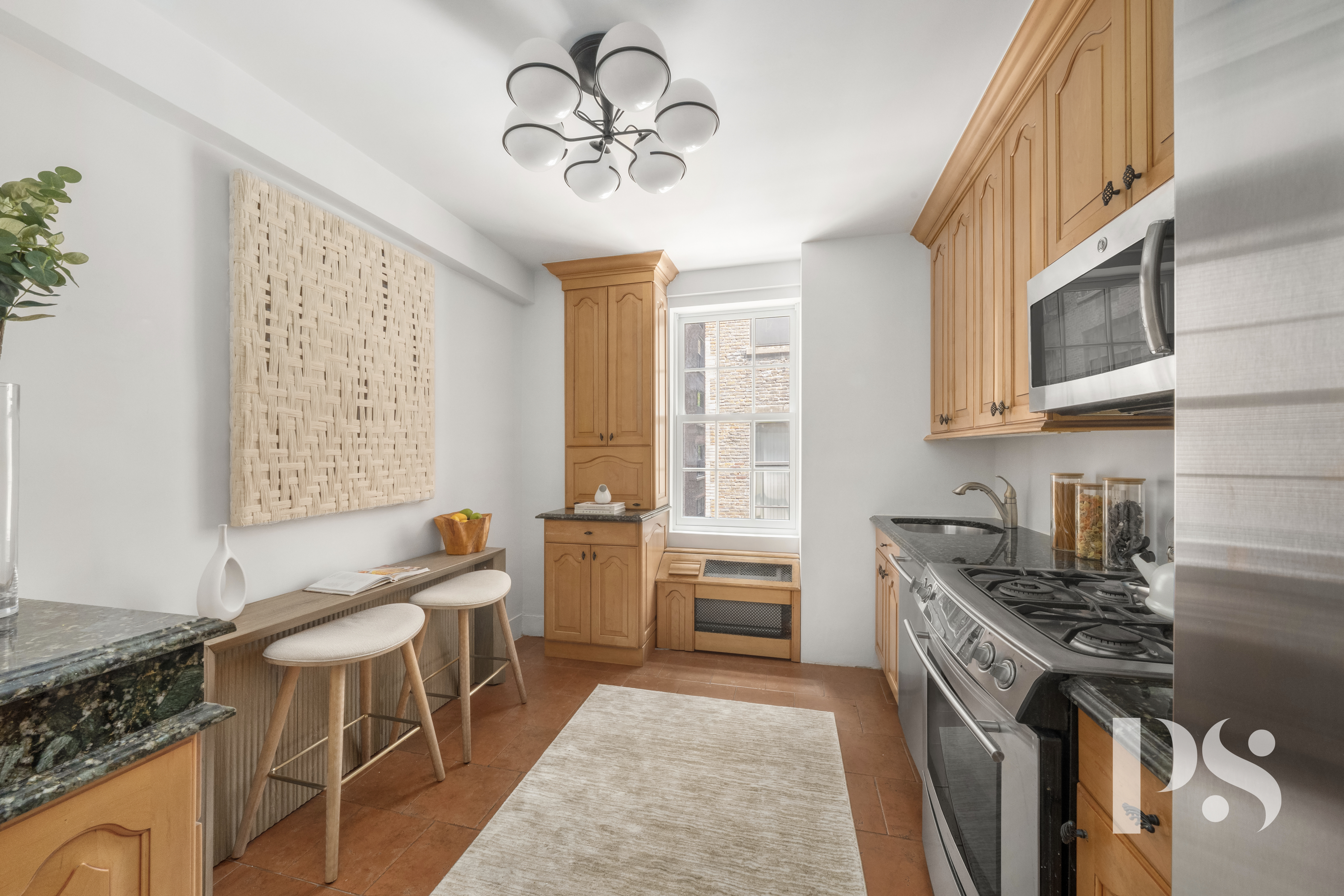 35 East 9th Street, Unit 33 Manhattan, NY 10003 - Photo 7 of 14 a kitchen with stainless steel appliances granite countertop a stove a sink dishwasher and cabinets with wooden floor
