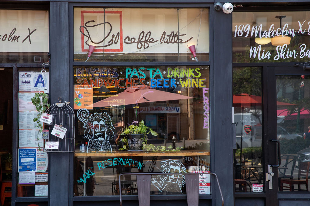 1787 Madison Avenue, Unit 402 Manhattan, NY 10035 - Photo 11 of 13 a view of a cafe with a couple of people