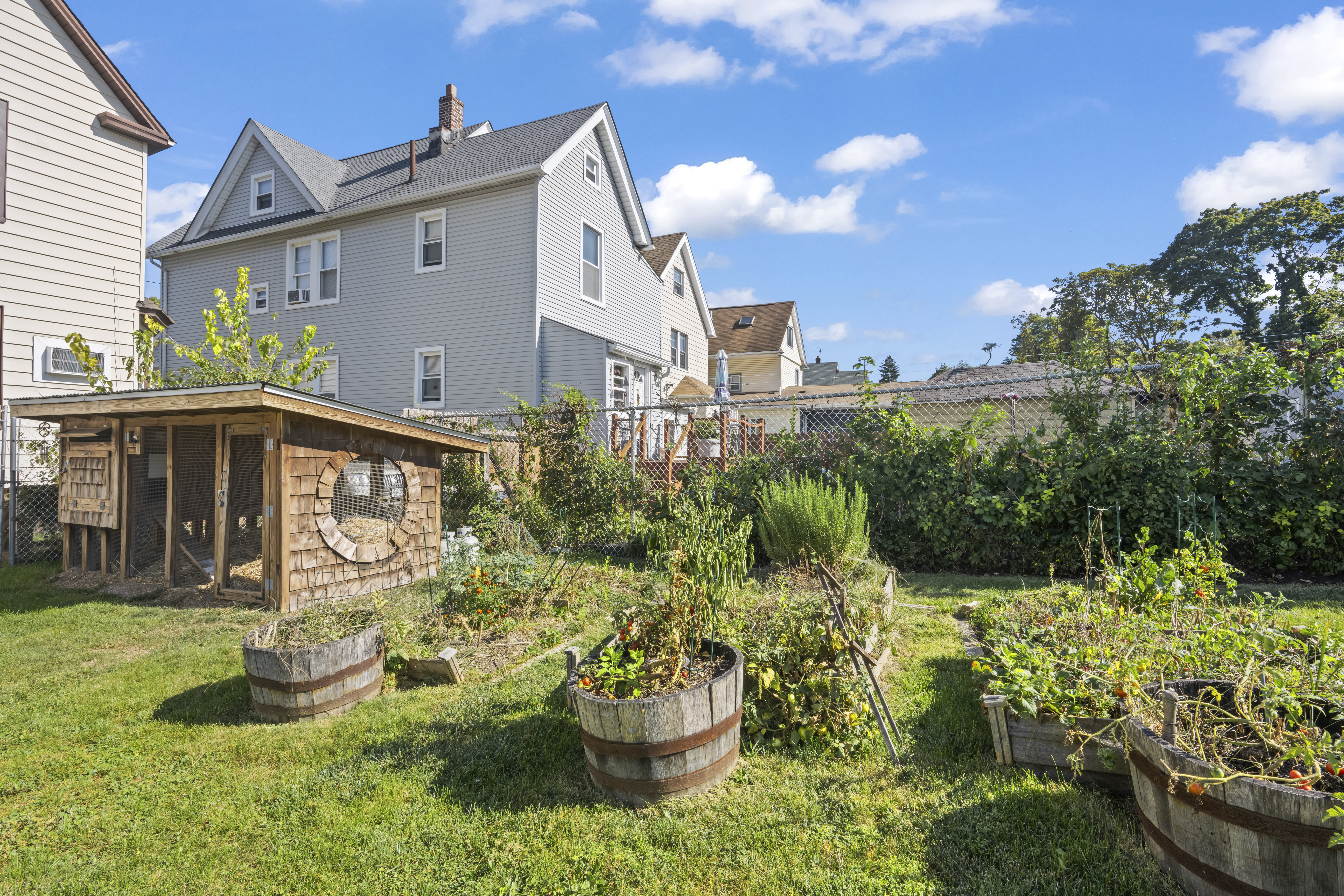 704 Delafield Avenue Staten Island, NY 10310 - Photo 24 of 35 a front view of a house with a yard fountain and a fire pit