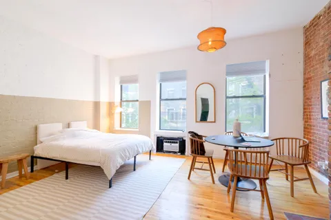 a bedroom with a bed and a table