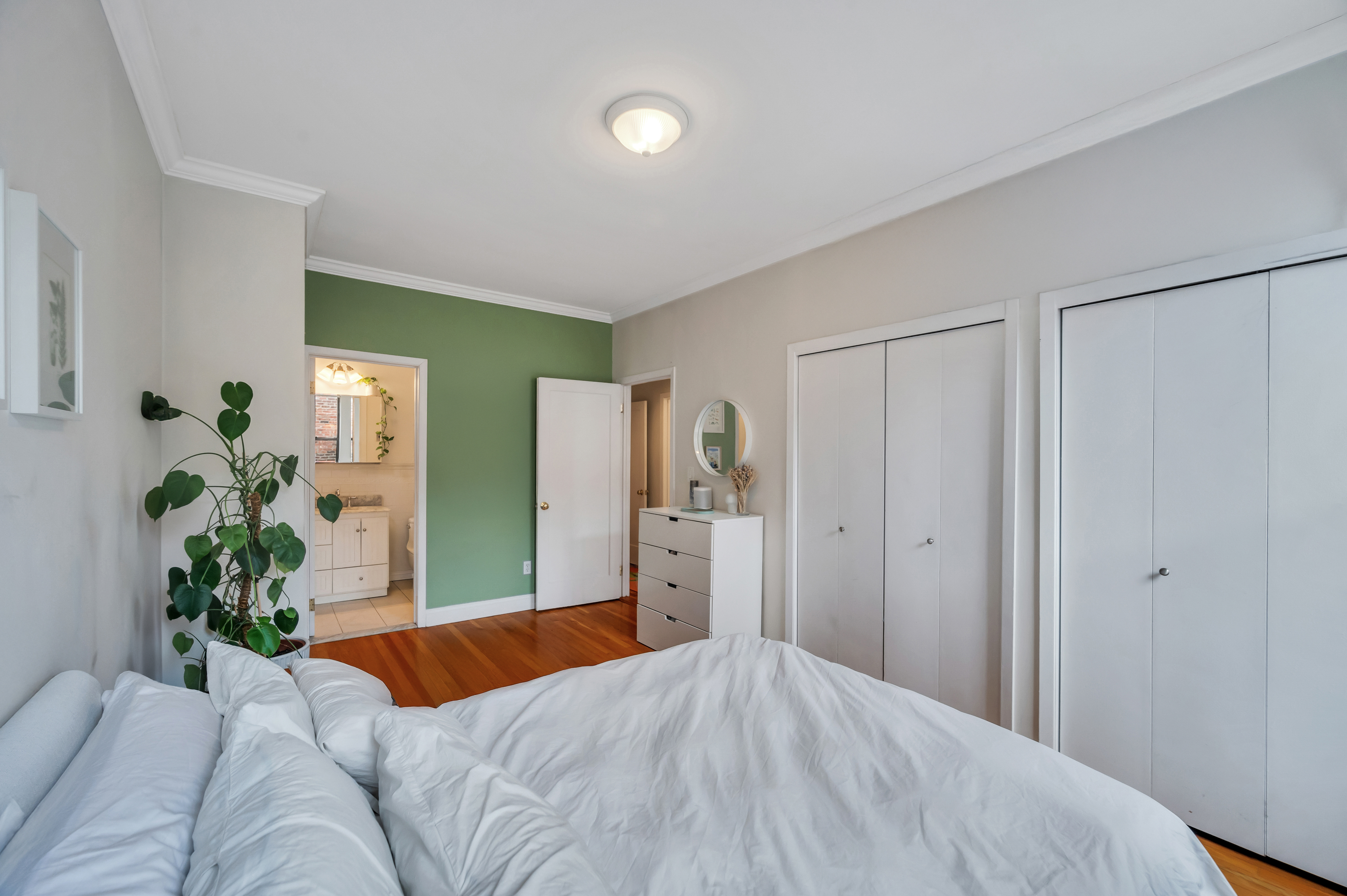 120 2nd Avenue, Unit 5A Manhattan, NY 10003 - Photo 7 of 13 a bedroom with a large bed and potted plant
