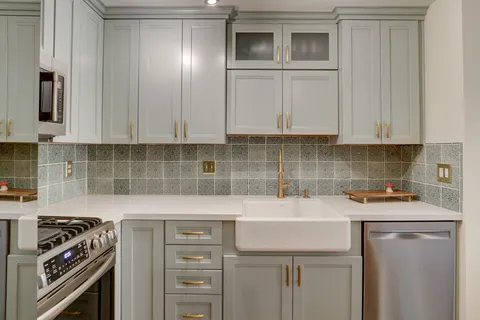 a kitchen with a sink stove and cabinets