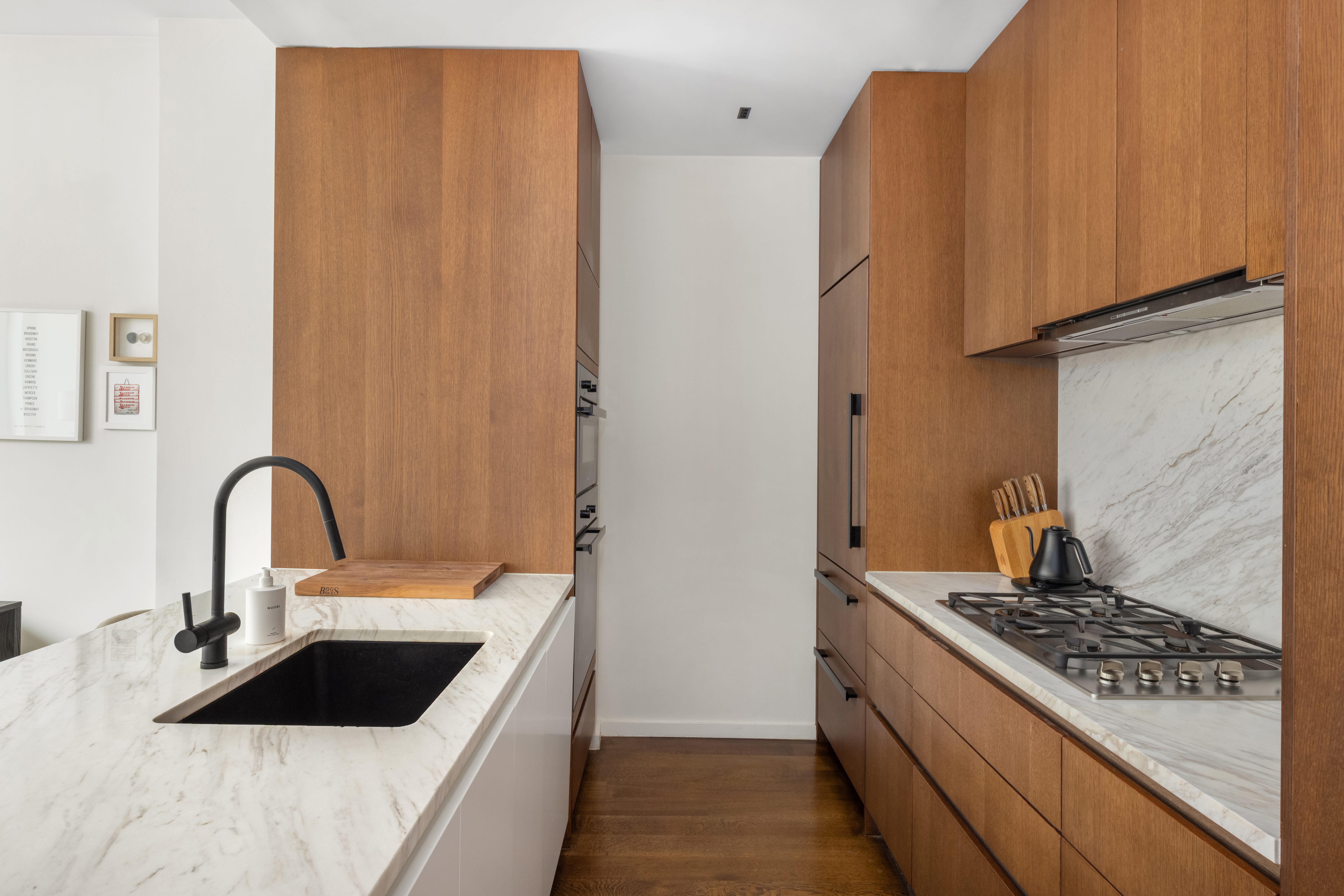 570 Broome Street, Unit 6A Manhattan, NY 10013 - Photo 5 of 17 a kitchen with a sink and a stove top oven