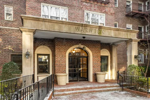 a view of a brick house with large windows