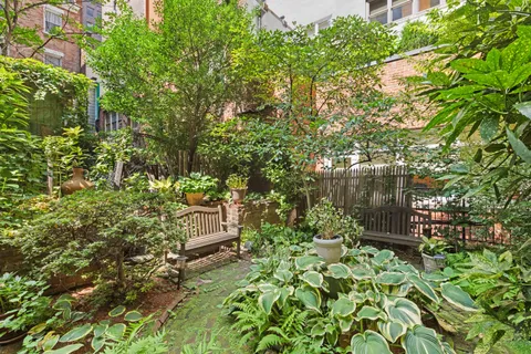 a backyard of a house with lots of green space and garden