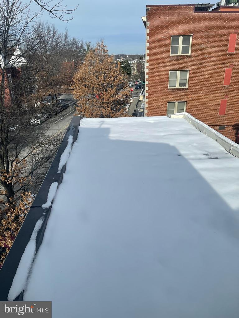 1033 Park Road Northwest, Unit 6 Washington, DC 20010 - Photo 20 of 38 a view of a brick building next to a yard