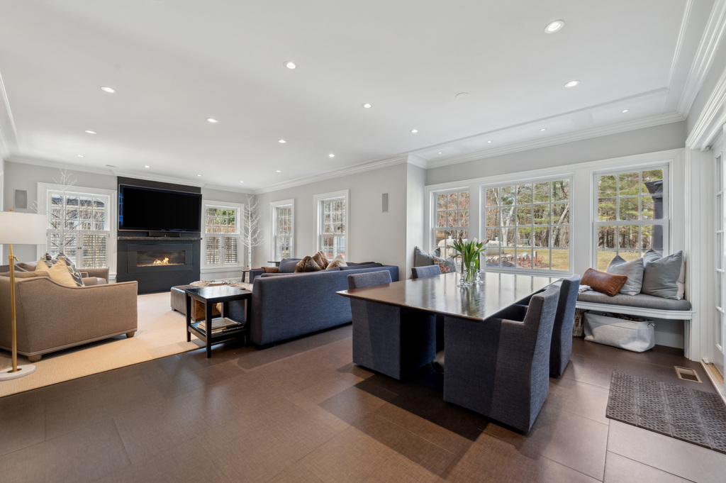 79 Pine Street Dover, MA 02030 - Photo 13 of 25 a living room with furniture a flat screen tv and a large window