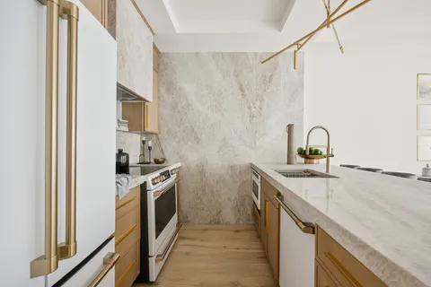 a kitchen with a sink and a stove top oven