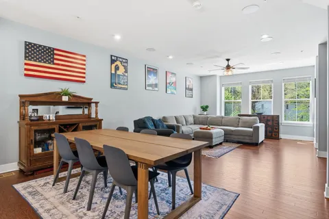 a living room with furniture and a wooden floor