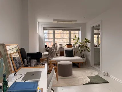 a living room with furniture and large windows