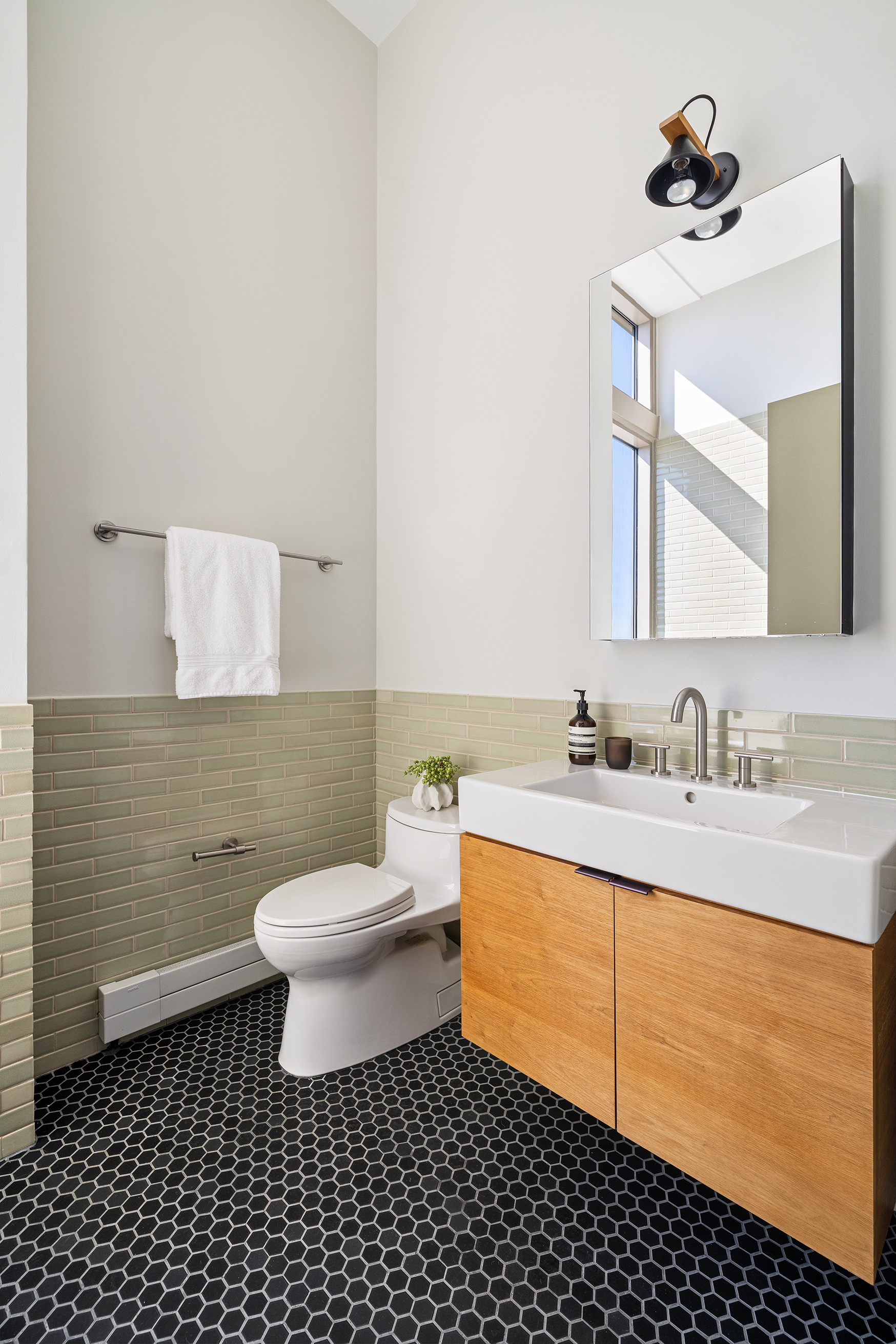 144 North 8th Street, Unit 12A Brooklyn, NY 11249 - Photo 16 of 21 a bathroom with a sink a toilet and mirror