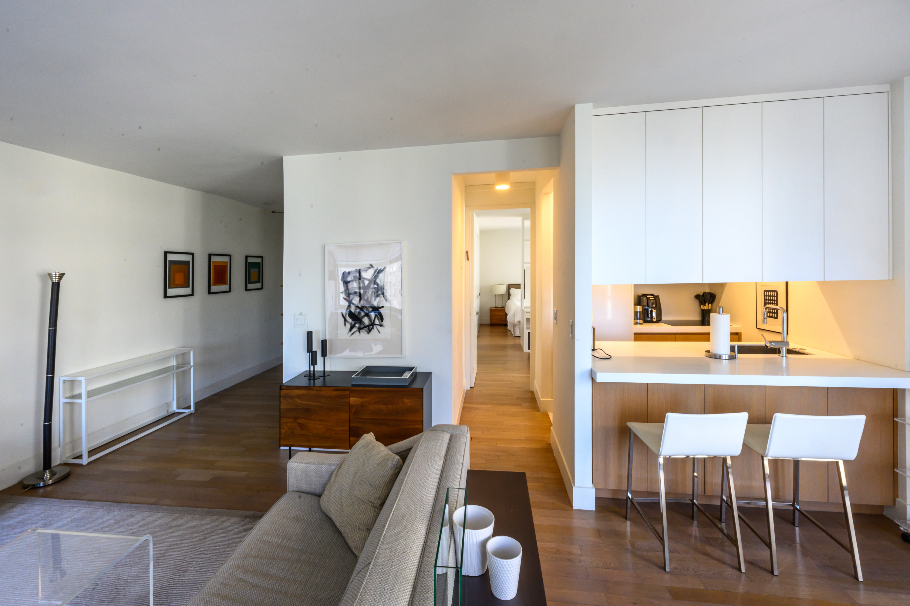 200-210 East 65th Street, Unit 11D Manhattan, NY 10065 - Photo 4 of 15 a living room with furniture and a couch