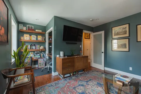 a living room with furniture and a bookshelf