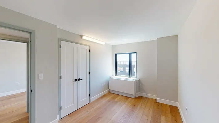 605 Hart Street, Unit 506 Brooklyn, NY 11221 - Photo 4 of 12 a view of room with wooden floor and tub