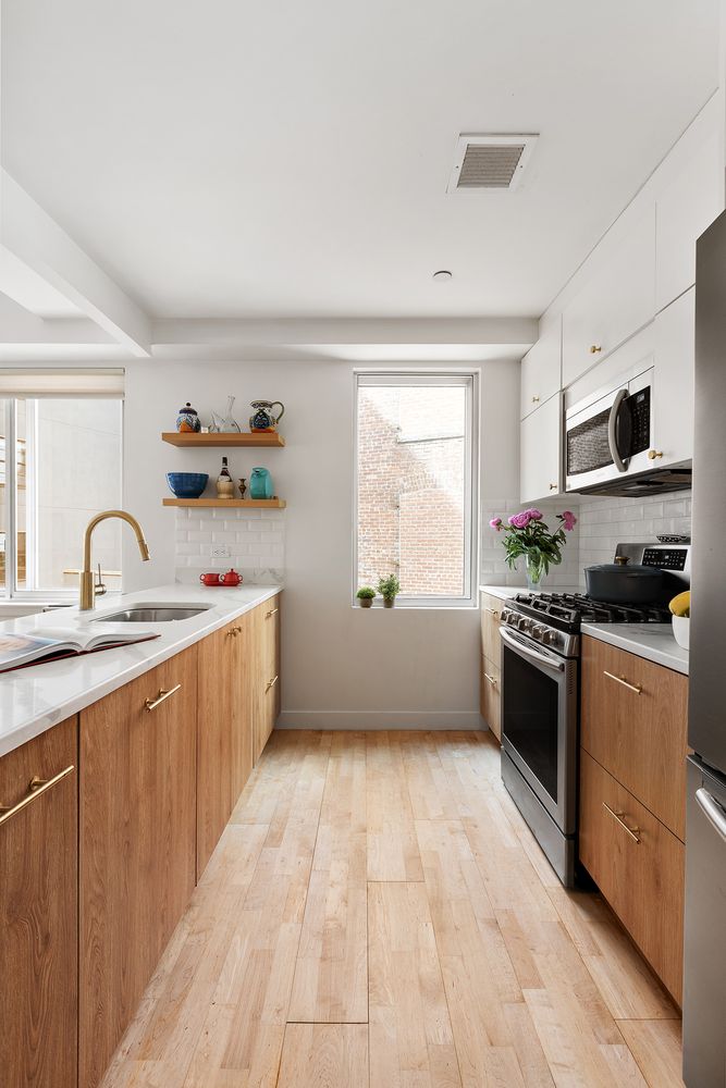 a kitchen with a sink cabinets and window