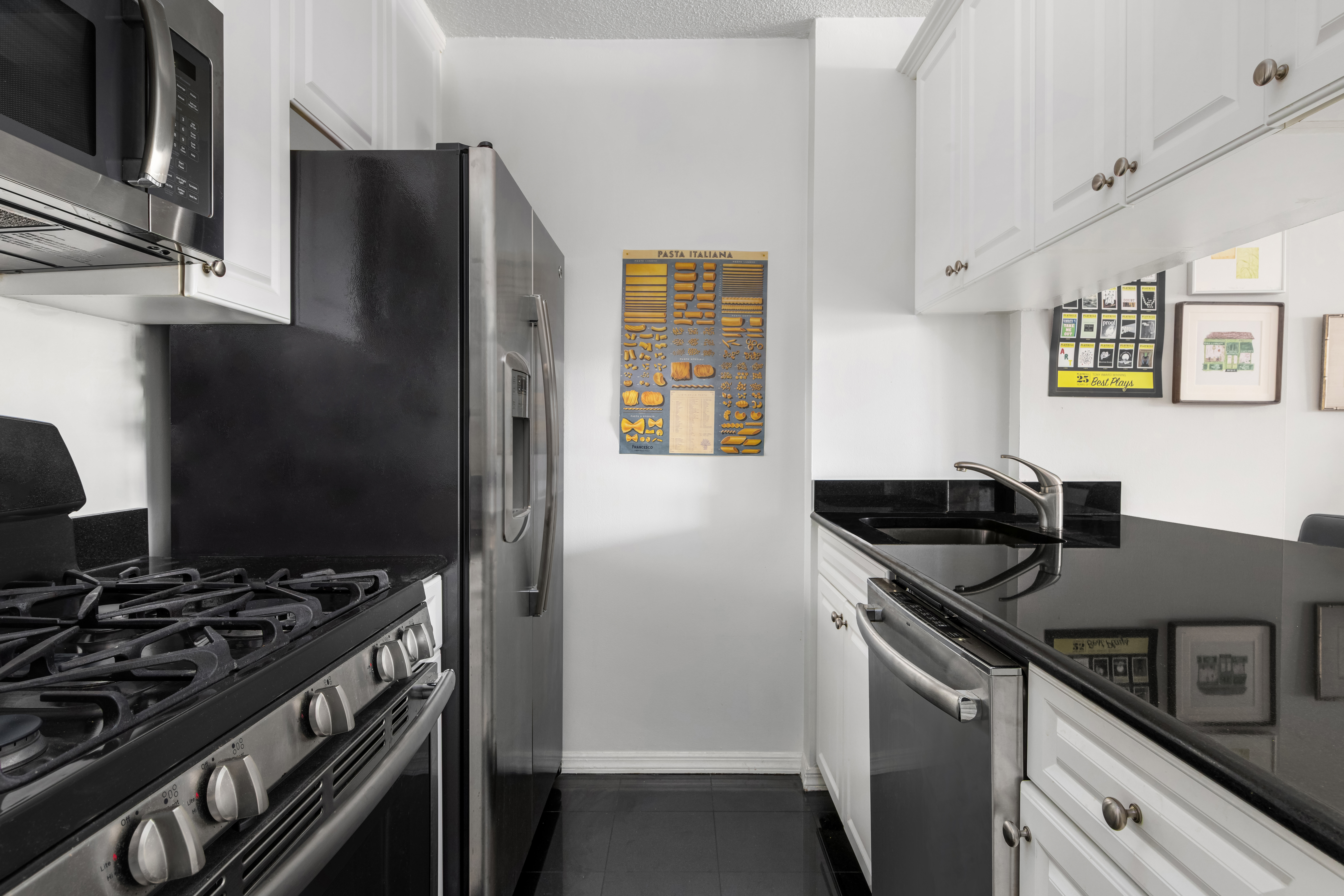 151-155 East 31st Street, Unit 12C Manhattan, NY 10016 - Photo 3 of 7 a kitchen with stainless steel appliances granite countertop a stove and a refrigerator