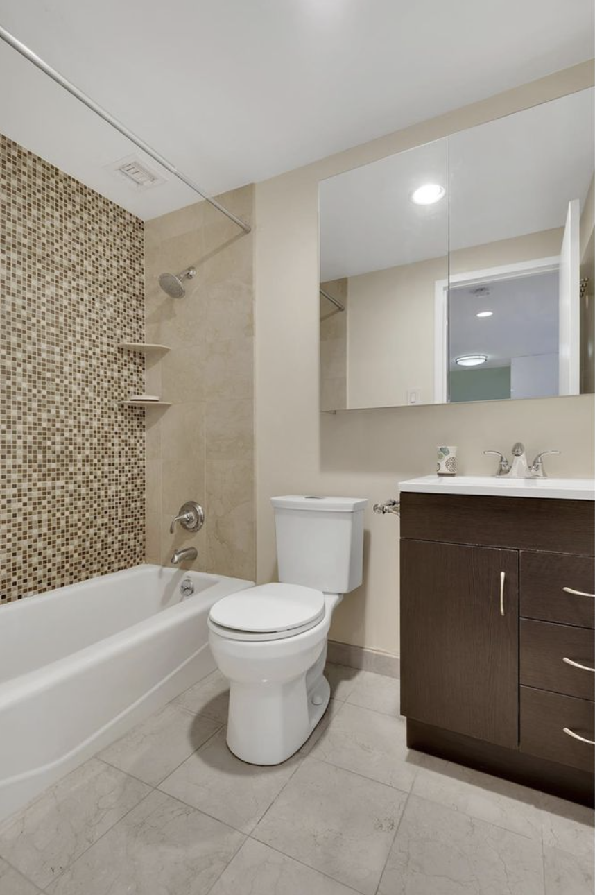 445 West 19th Street, Unit 5G Manhattan, NY 10011 - Photo 4 of 7 a bathroom with a sink a toilet and shower