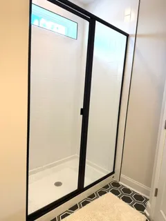 a bathroom with a shower and a sink