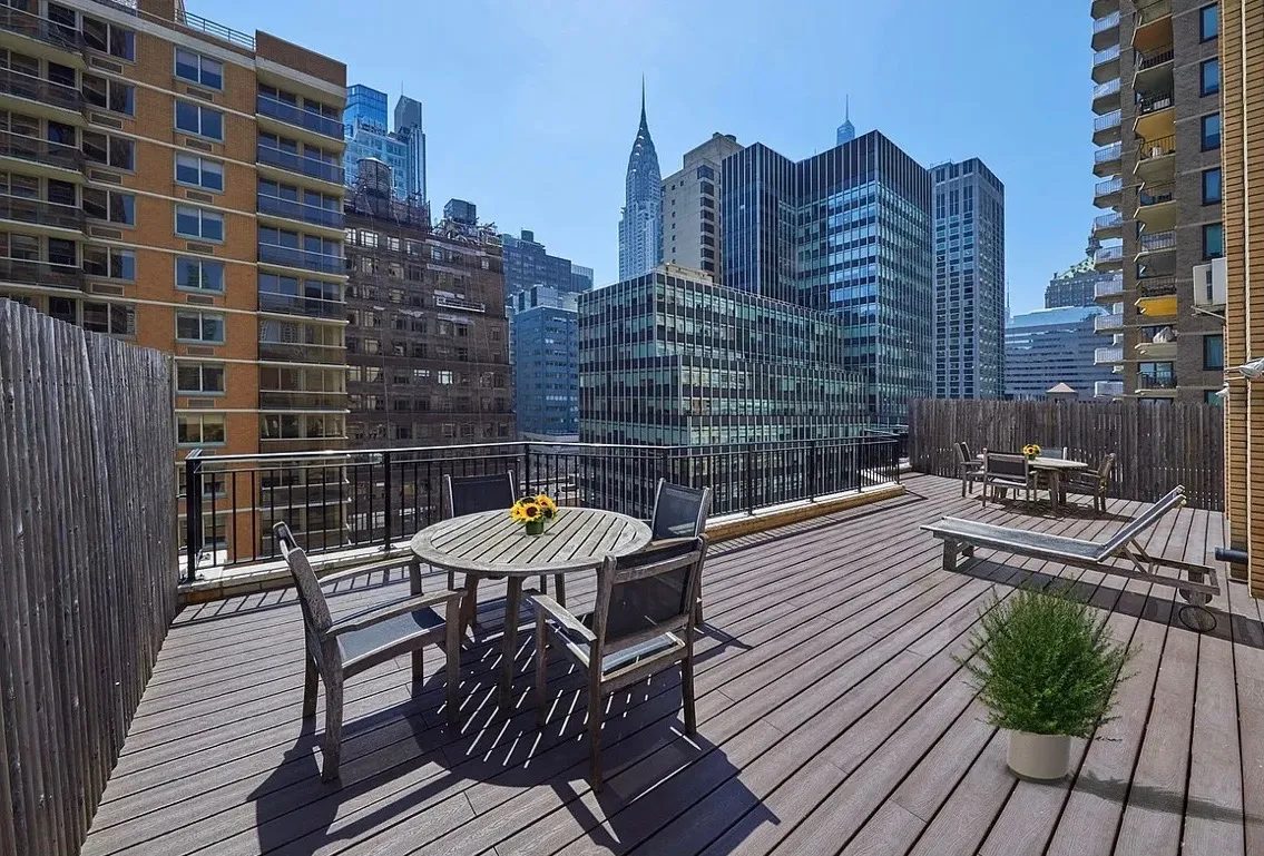a view of a balcony with a table and chairs