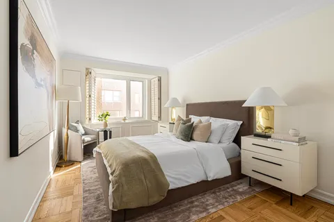 a bathroom with a sink a toilet a mirror and shower