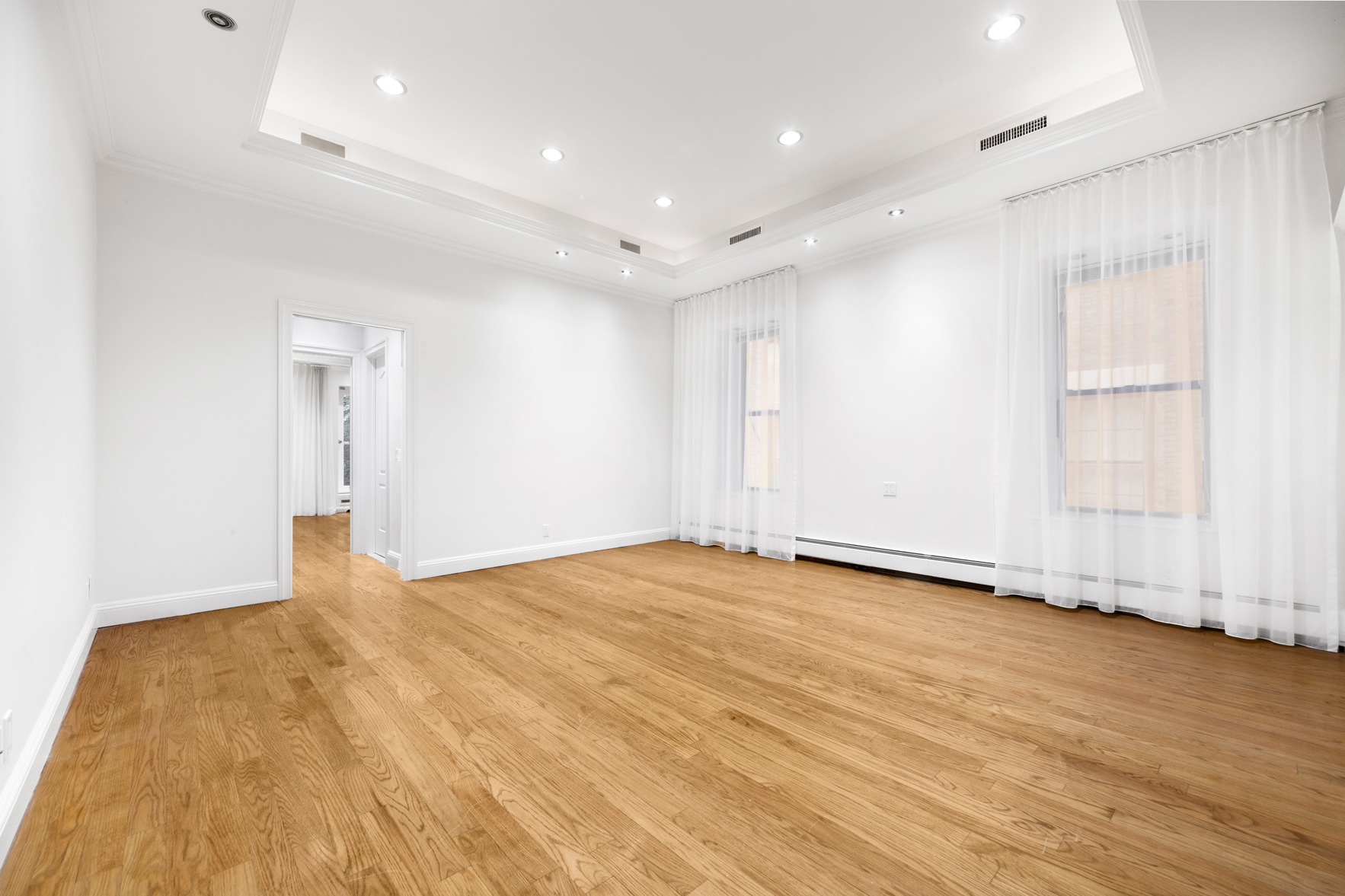 34 East 64th Street, Unit 2 Manhattan, NY 10065 - Photo 5 of 7 a view of an empty room with wooden floor