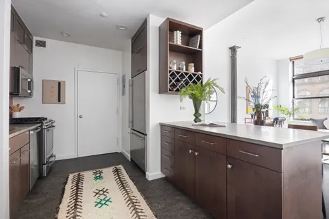 a kitchen with stainless steel appliances a sink stove and refrigerator