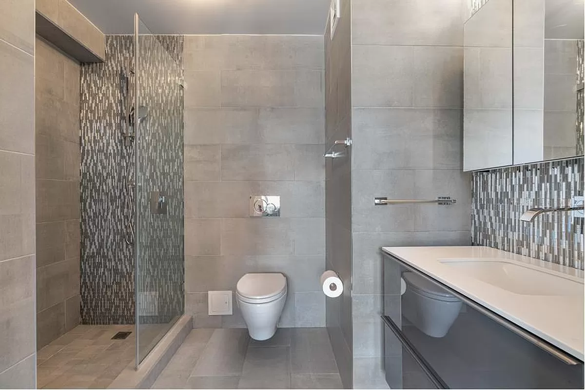 401 East 74th Street, Unit 20F Manhattan, NY 10021 - Photo 13 of 22 a bathroom with a sink a toilet and shower