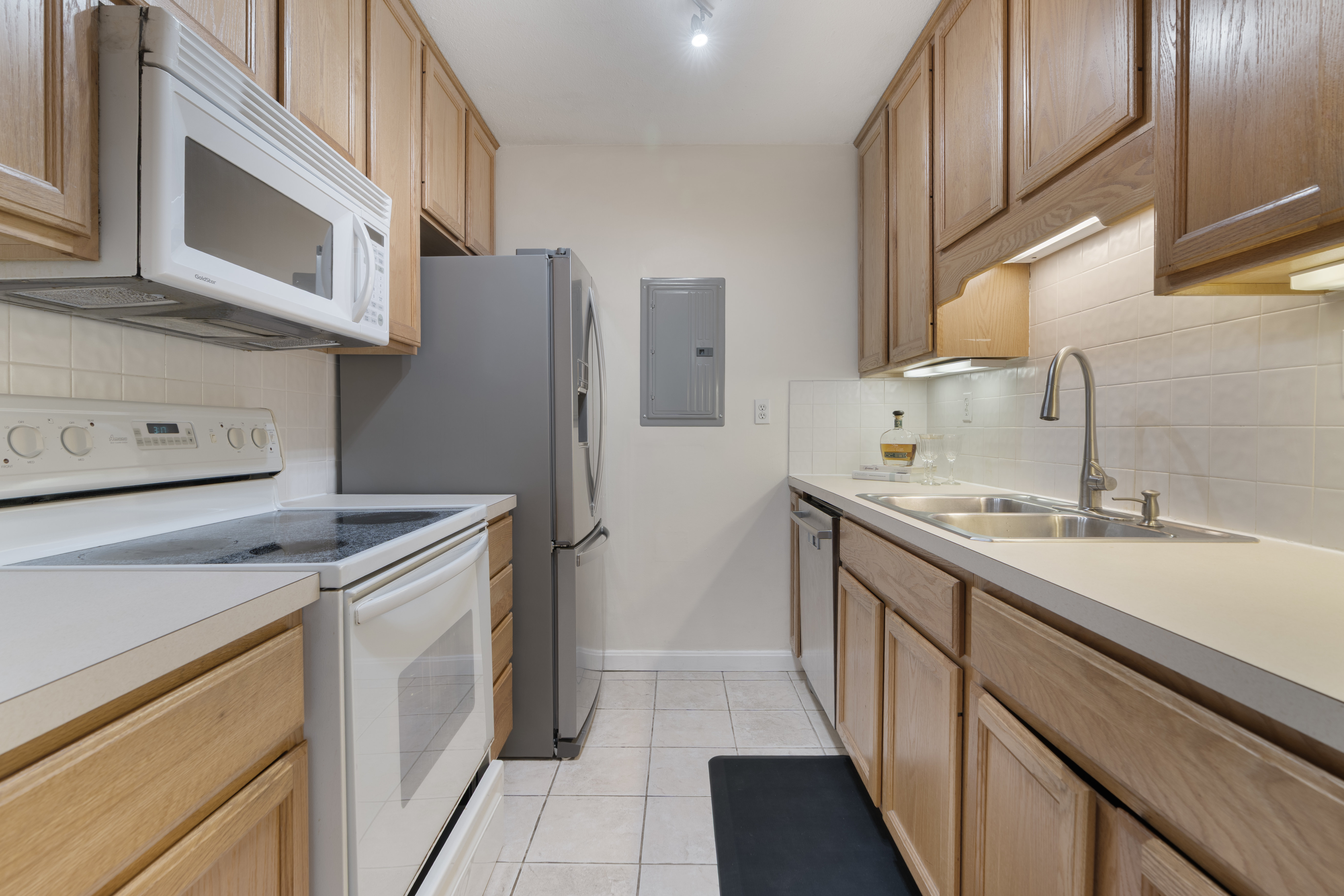566 Commonwealth Avenue, Unit 1100 Boston, MA 02215 - Photo 5 of 13 a kitchen with a sink and a refrigerator