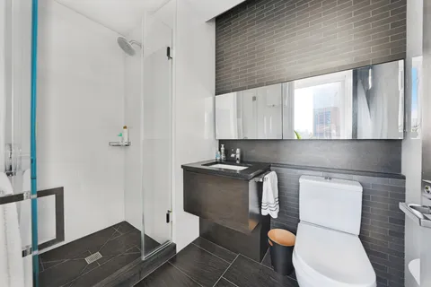 a kitchen with a toilet a sink and a stove