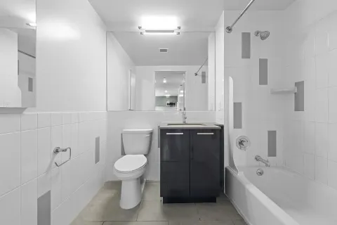 a bathroom with a sink a toilet and shower