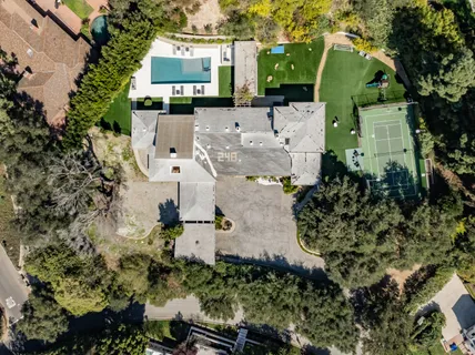 an aerial view of a house with a yard