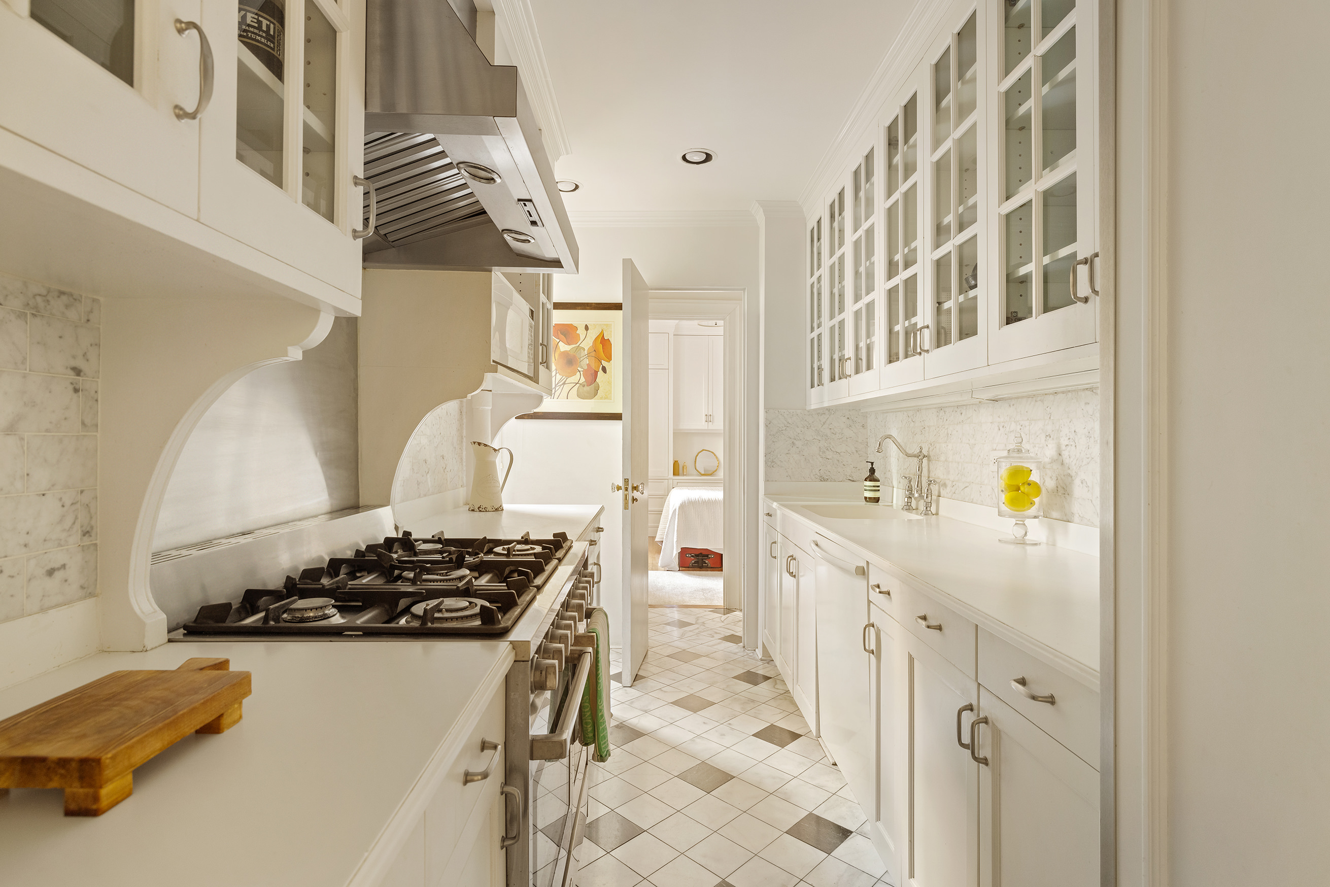 119 East 84th Street, Unit 4C Manhattan, NY 10028 - Photo 4 of 9 a kitchen with stainless steel appliances a stove a sink and a refrigerator