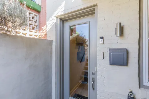 a bathroom with a granite countertop mirror and a shower