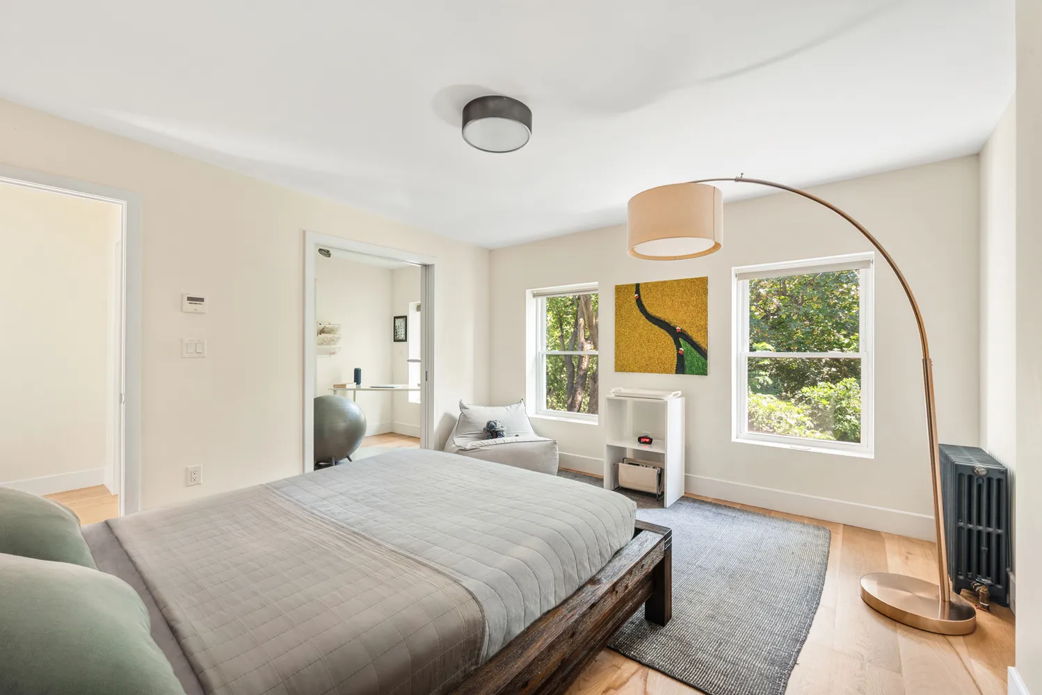 a bedroom with a bed and a large window with outer view