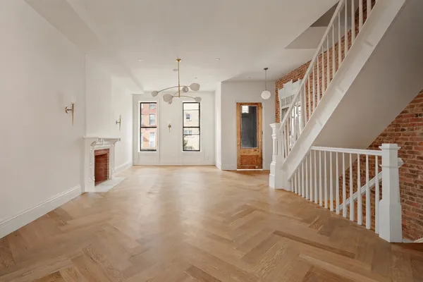 an empty room with windows and entryway