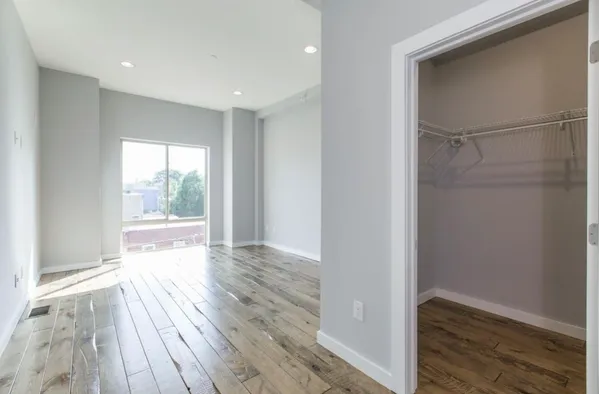 a view of hallway with wooden floor