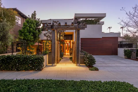 a view of hallway with stairs and wooden floor