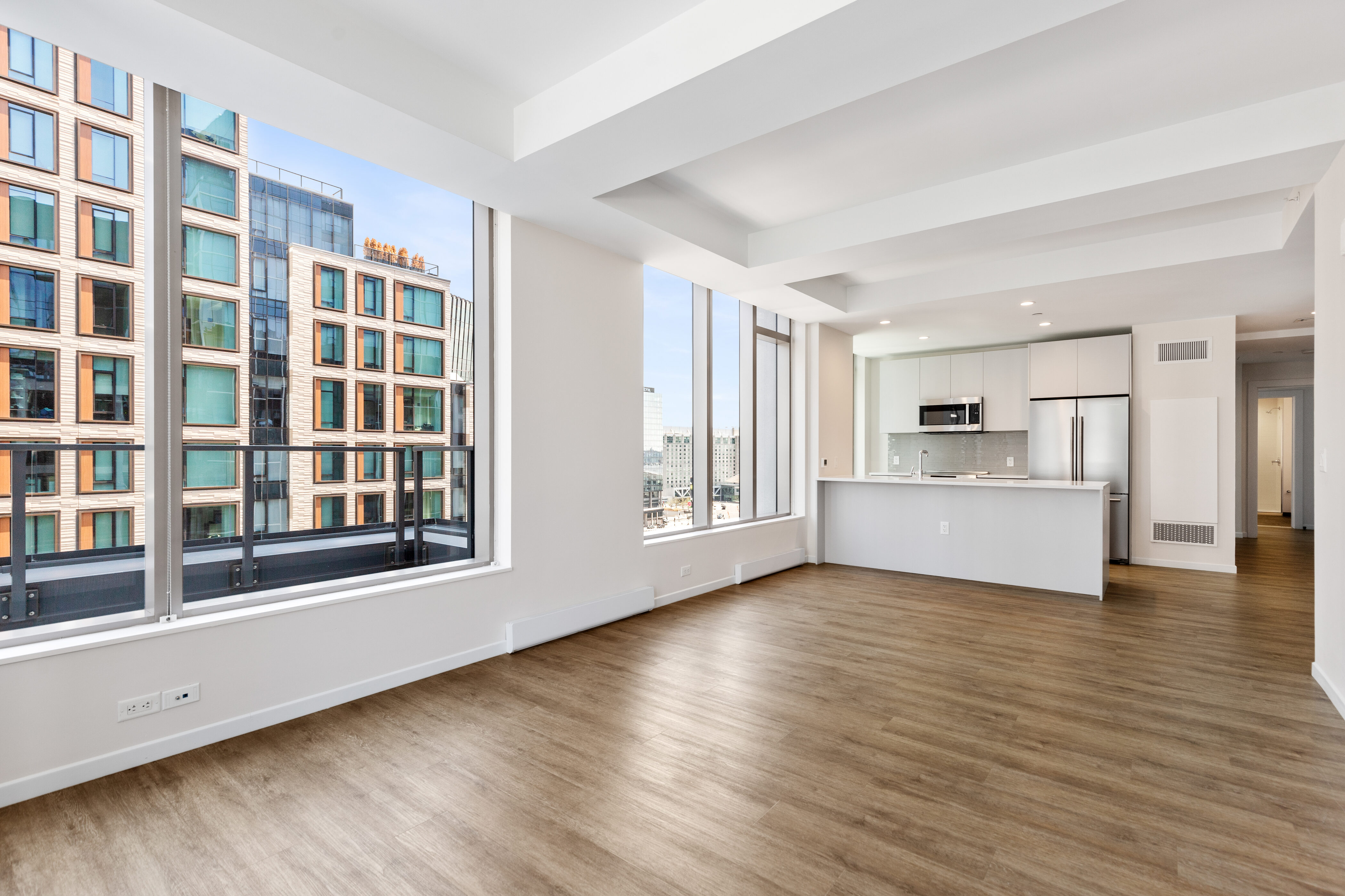131 Seaport Boulevard Boston, MA 02210 - Photo 2 of 11 a view of an empty room with a window and wooden floor