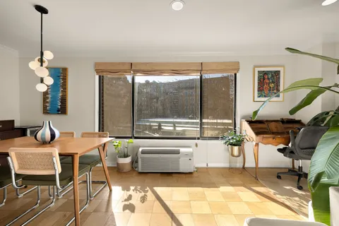 a view of a dining room with furniture window and outside view
