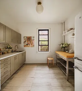 a large white room with a window and furniture