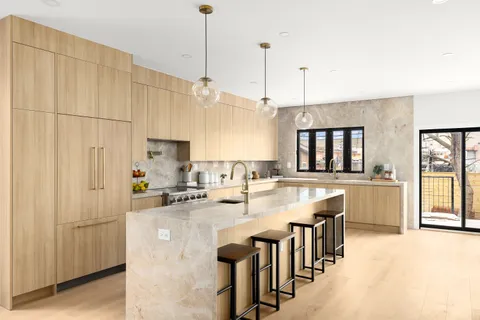 a kitchen with kitchen island granite countertop lots of counter top space and stainless steel appliances