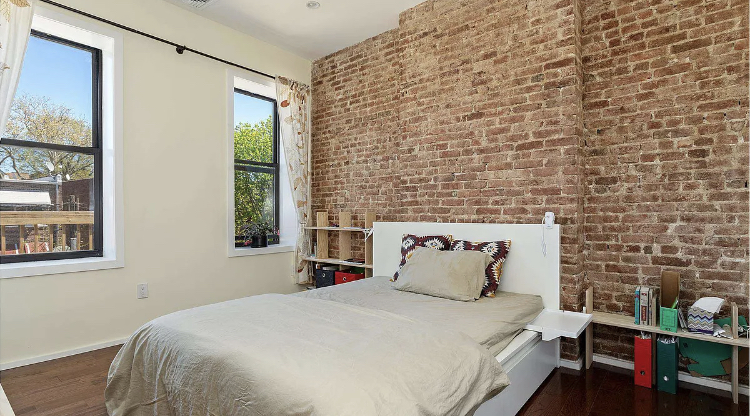 201 East 31st Street, Unit 2 Brooklyn, NY 11226 - Photo 2 of 6 a bed sitting in a bedroom next to a window