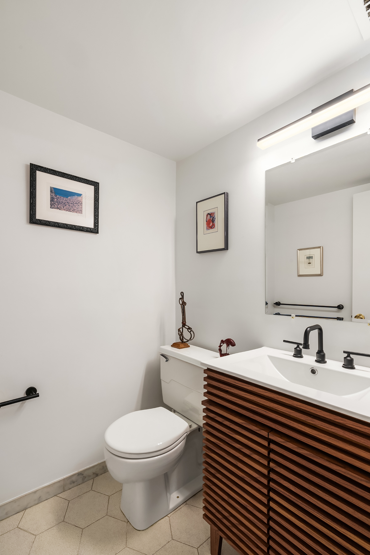 248 East 31st Street, Unit 1D Manhattan, NY 10016 - Photo 11 of 13 a bathroom with a sink a toilet and mirror