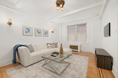 a living room with furniture a fireplace and a table