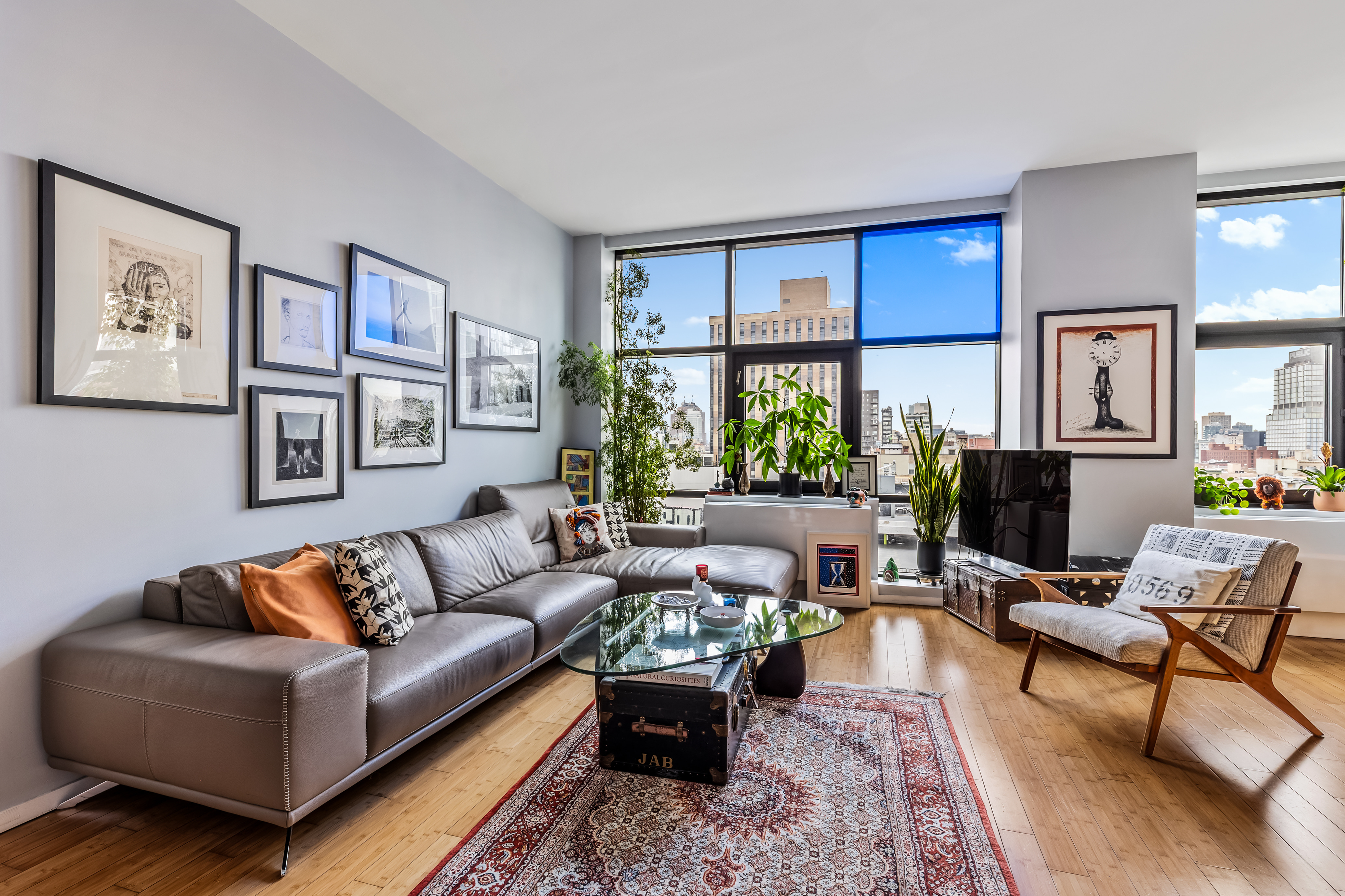 105 Norfolk Street, Unit 10A Manhattan, NY 10002 - Photo 2 of 11 a living room with furniture and a large window